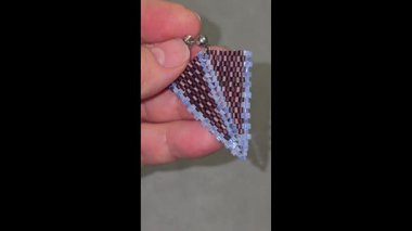 Handmade beaded and glass bead earrings on a light background. Copy space