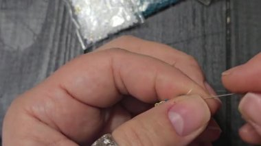 A pink handmade bracelet made of Japanese beads on a light background. Decor: glass bead weaving.