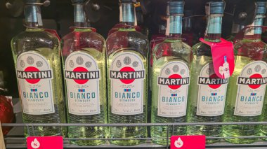 Bottles of Martini on a store counter. Alcohol sales. Supermarket display. Product selection.