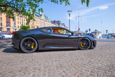 City Stocholm, Sweden. Exclusive Ferrari car at street. Urban city view. Travel photo 2018 clipart