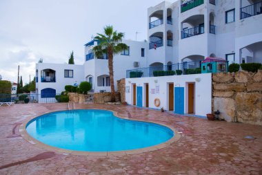 Şehir Paphos, Kıbrıs. Yüzme Havuzu. Doğa ve binalar adada. Seyahat fotoğraf 2018. Aralık, ağaçlar ve güneş.
