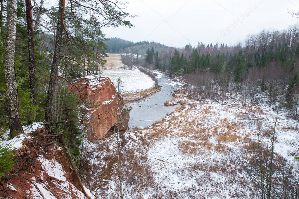 City Cesis, Latvia, river Amata. Red cliffs and river in winter. Snow and rocks, travel photo 2018. 30. december.