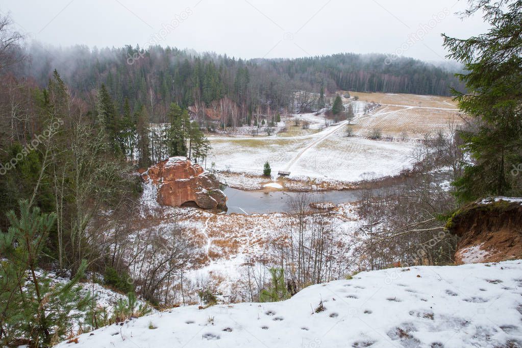 City Cesis, Latvia, river Amata. Red cliffs and river in winter. Snow and rocks, travel photo 2018. 30. december.