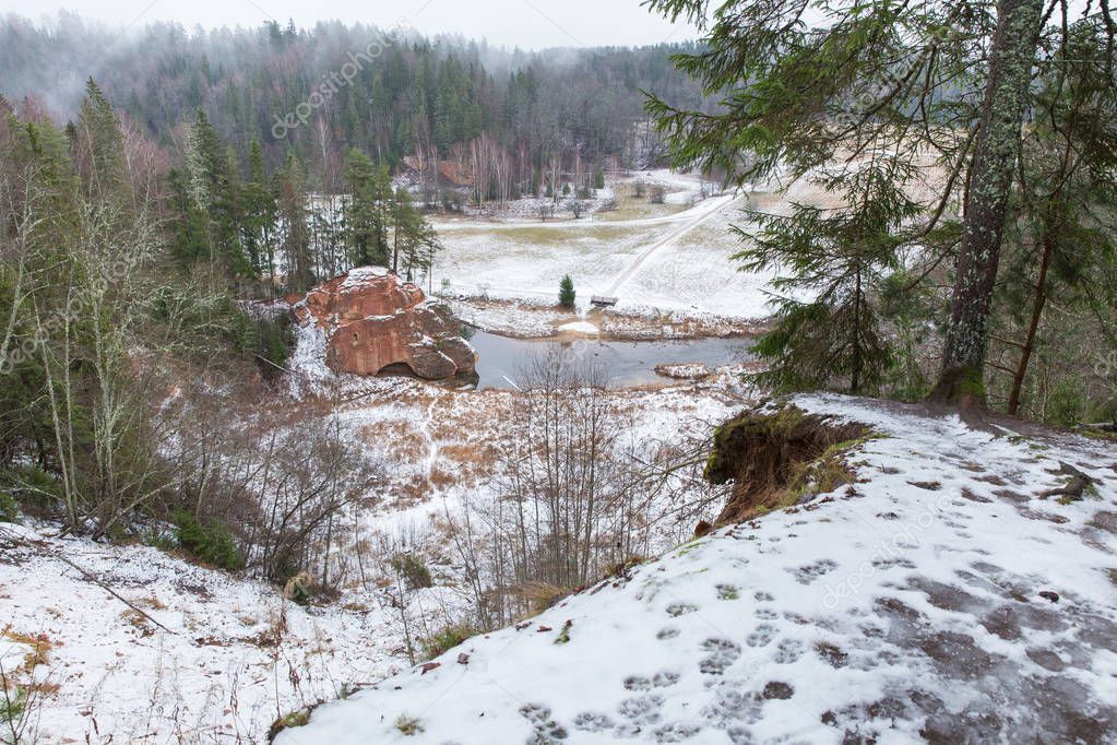 City Cesis, Latvia, river Amata. Red cliffs and river in winter. Snow and rocks, travel photo 2018. 30. december.
