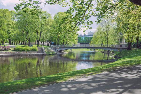 City Riga, Latvia Republic. City park with bridge and buildings.
