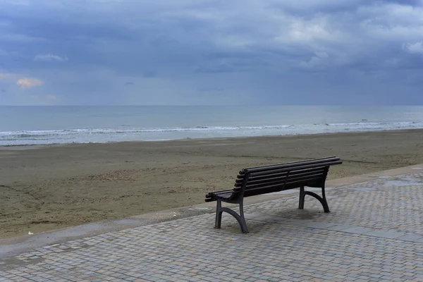 Bench on the deserted seashore. Minimalism. Seascape