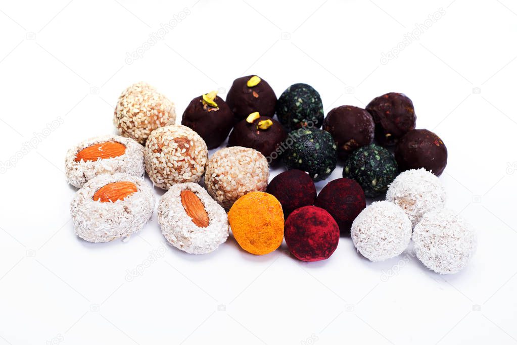 Raw vegan healthy candy on a white background. Isolated objects. Place for text. Homemade diet sweets