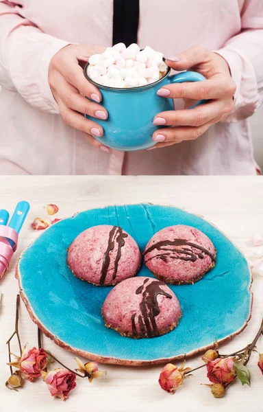 Vegan cashew cakes on a blue plate. In the background is a fragment of the female body. Delicious and healthy breakfast without sugar