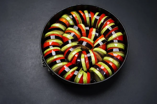 Ingredients for cooking Provencal cuisine ratatouille. Raw eggpl