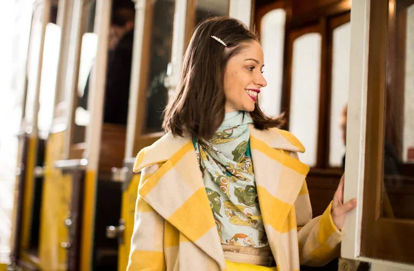 有名な黄色い路面電車の中でポーズをとる美しい女性 リスボン ストック画像