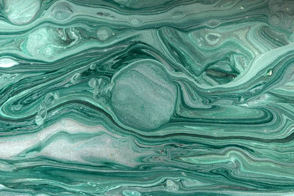 Gold marbling texture design. Green and golden marble pattern. Fluid art.