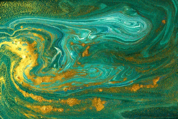 Liquid uneven green marbling pattern with golden glitter and glare of light