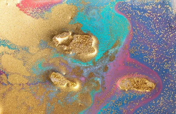 Golden glitter scattering background. Sparkling gold, blue and pink texture.