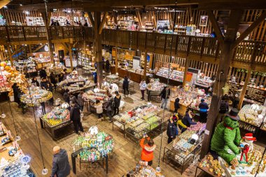 HOKKAIDO, JAPAN - 30 DECEMBER 2017 - Tourists enjoy shopping inside the Music Box Museum Shop in Otaru, Hokkaido, Japan on December 30, 2017 clipart