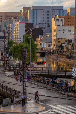 Yayalar yağmurlu bir üzerinde Fukuoka, Japonya'nın işlek sokaklarında yürümek