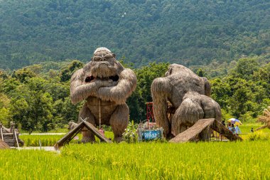Chiang Mai, Thailand - 12 September 2020 - Gorilla statues and other animal made from straws stand on display at Huai Thung Tao Lake for tourists and visitors to enjoy on September 12, 2020 in Chiang Mai, Thailand clipart