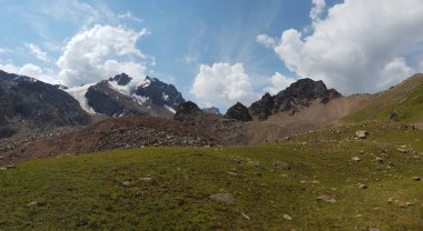 Dağların tepesinde bulutlarla kaplı manzara.