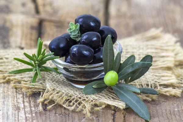 black olives and herbs in a bowl