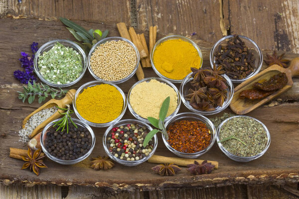 Variety of spices on wooden background