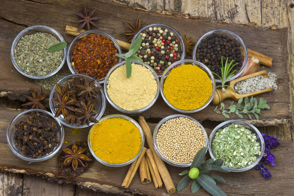 elevated view of variety of spices on wooden background