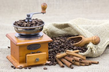 Tarçın çubukları, kahve çekirdekleri ve kahve öğütücüsü. 