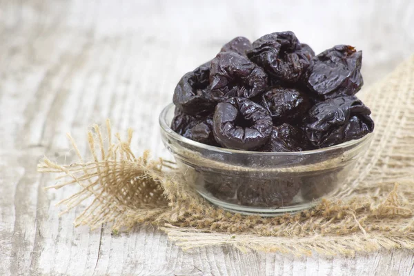 Bowl full of dried plums — Stock Photo, Image