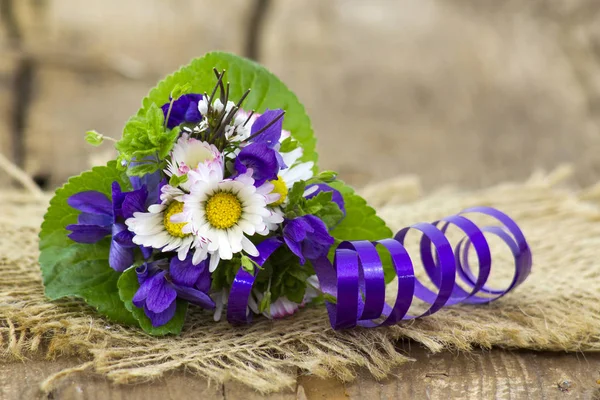 Viola odorata and daisies -  spring flowers bouquet Stock Image