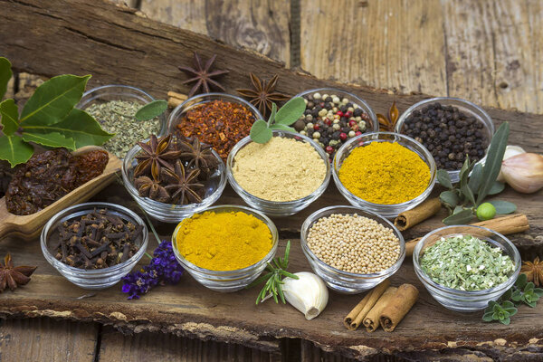 Variety of spices on wooden background