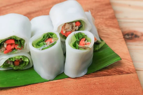 spring roll with vegetable on banana leaf wood floor background , Select focus  shallow depth of field.