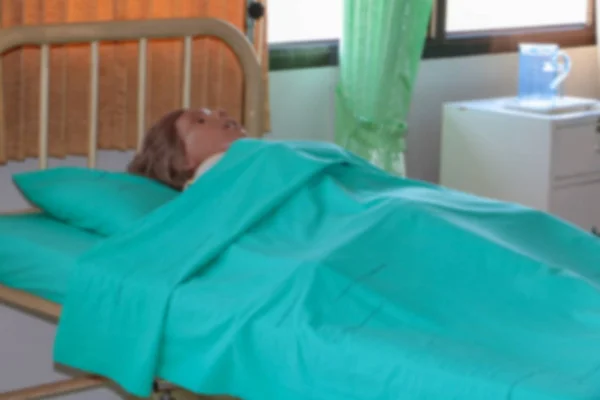 blurred Medical dummy in hospital, training Medical course education on bed and blanket green