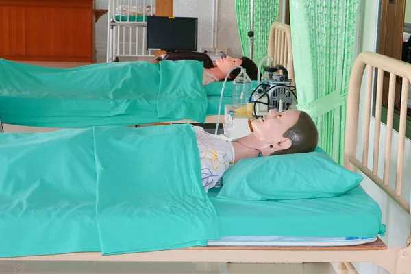 Medical dummy in hospital, training Medical course education on bed and blanket green