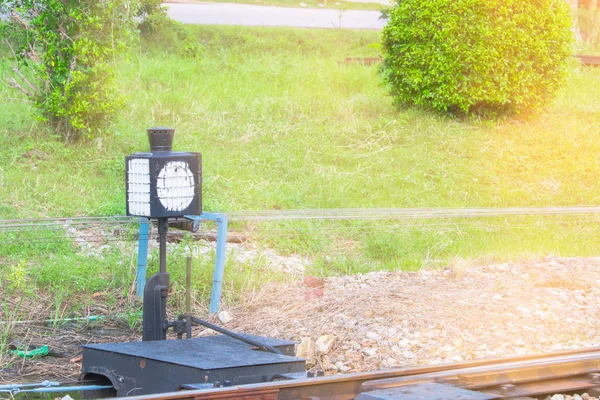 old operated railroad switch and signal  the traffic railway train with sun yellow light