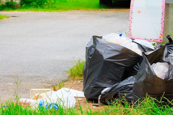 Pila bolsa de basura negro carretera en la ciudad con espacio para copiar —  Fotos de Stock
