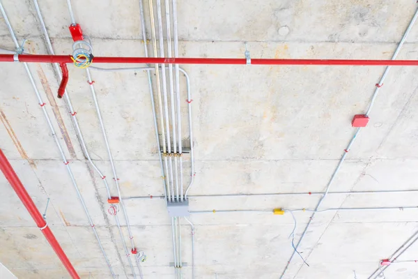 Tuberías metálicas en Construcción y rociadores contra incendios en tubería roja — Foto de Stock