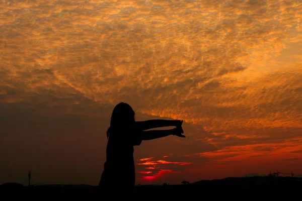 Silueta de ejercicios de mujer al atardecer Amarillo en el cielo — Foto de Stock