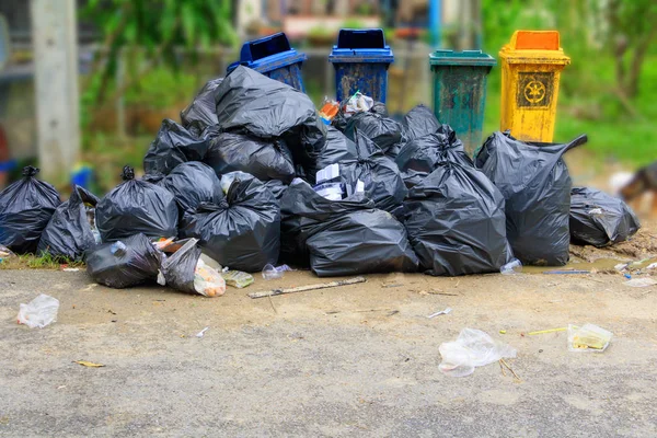 Lixo de pilha saco preto beira de estrada de plástico na cidade — Fotografia de Stock