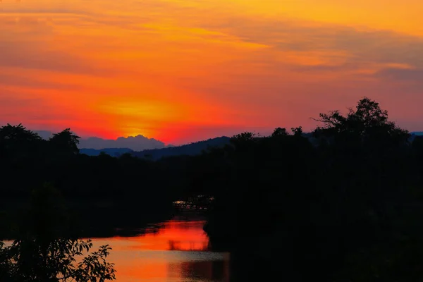 Solnedgång i sky vackra färgstarka landskap och siluett träd — Stockfoto