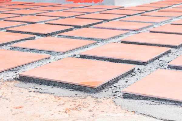 row tile ceramic orange on floor install with cement