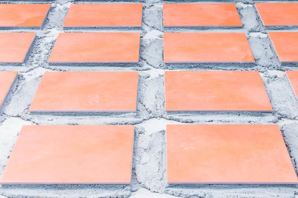 row tile ceramic orange on floor install with cement in work construction