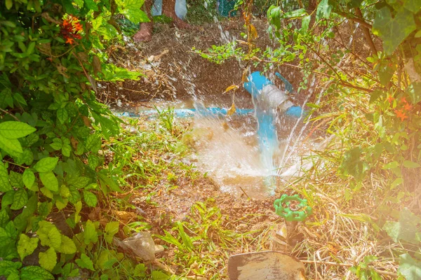 broken pipe in hole with water motion at roadside wait repair