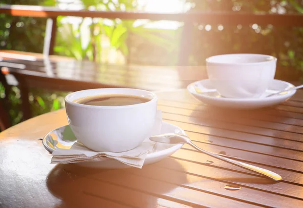 Café negro en taza blanco sobre tabla piso de madera fondo mañana — Foto de Stock