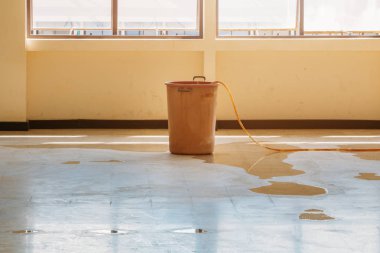 water leak drop interior office building in red bucket  clipart
