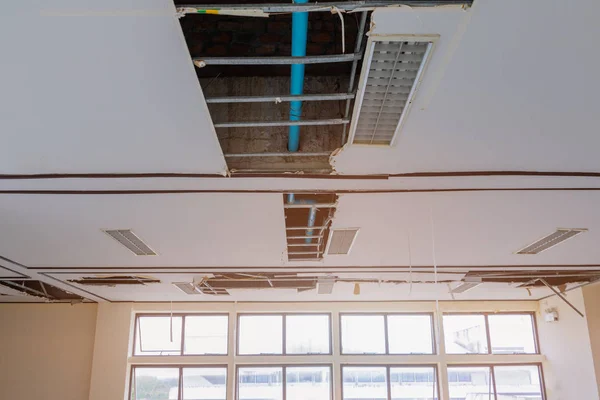 Repair leak water pipe on gypsum ceiling interior office — Stock Photo, Image