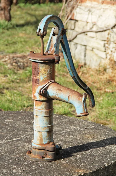 old chipped metal pump in the village