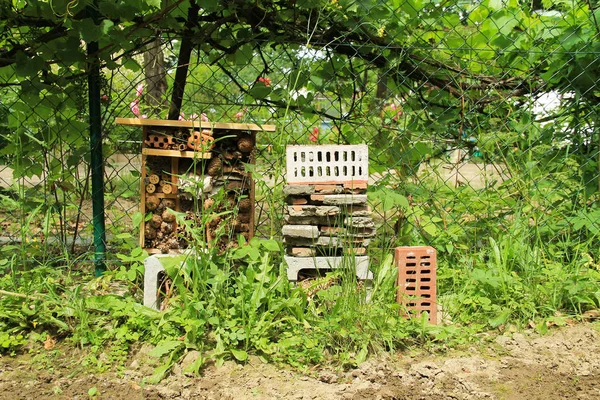 homemade insect hotel for various bugs and invertebrates in the garden in summer