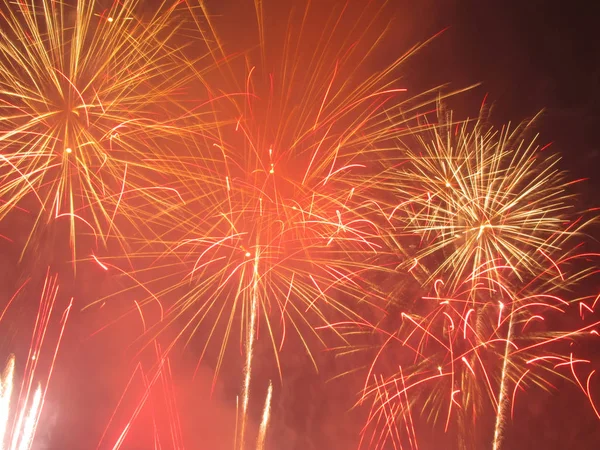 several bright explosions of red and yellow fireworks