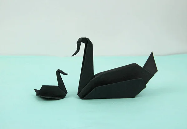 black origami paper swans, big and small, single parent concept