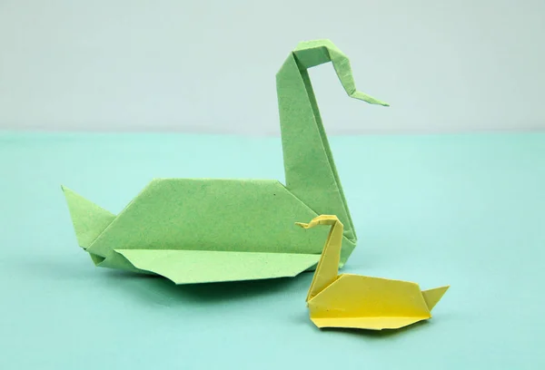 Big Green Paper Origami Swan Small Yellow One Adoption Concept — Stock Photo, Image