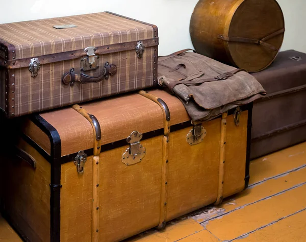 Large antique boxes for storing things stand on the wooden floor