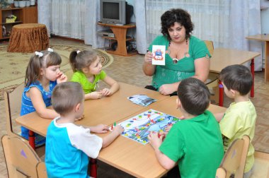 Gadjievo, Rusya - 13 Ocak 2011: Eğitimci çocuklarla ilgileniyor